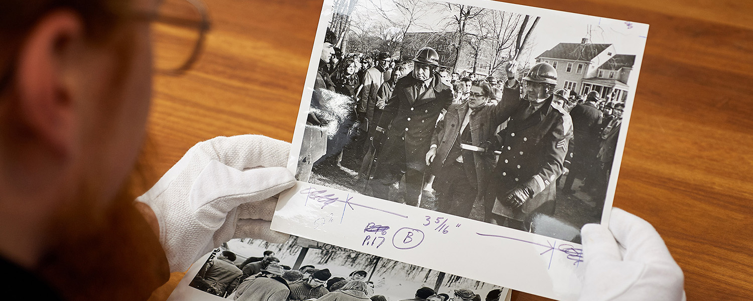 Graham Stinnett handles an archival photo.
